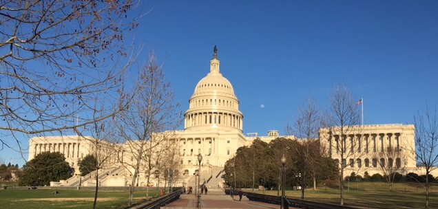 USA Capitol building with dark night sky and bright lights