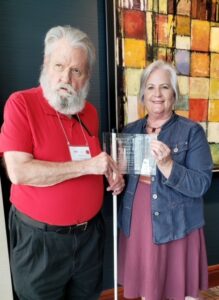Image of Zelda Gebhartd presenting the Bernice Kandarian Service Award to Roger Peterson during the 2022 ACB Convention
